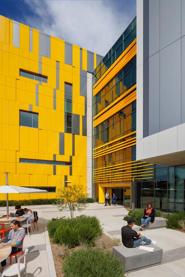 students sitting outside the II building